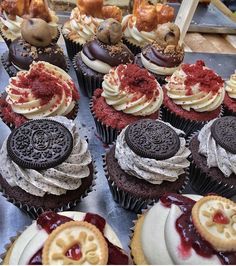 there are many cupcakes with different toppings on the top one is oreo cookies