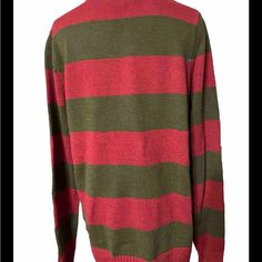 a green and red striped sweater on a mannequin