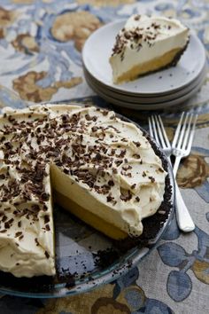 there is a pie with white frosting and chocolate sprinkles on it