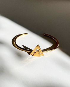 A striking cuff bracelet to complete your look This stylish Triangle Etched Cuff Bracelet is perfect for an edgy, beach look. Crafted from Mexican gold plated brass, this adjustable cuff bracelet is sure to give your look an extra touch of Californian flair. Trendy Adjustable Cuff Bracelet, Trendy Adjustable Brass Bracelets, Trendy Adjustable Gold Plated Cuff Bracelet, Trendy Adjustable Open Cuff Bracelet, Chic Adjustable Open Cuff Bracelet, Gold Resizable Bangle Cuff Bracelet, Adjustable Gold Plated Modern Cuff Bracelet, Adjustable Gold Open Cuff Bracelet, Symbolic Etched Cuff Bracelet Bangle