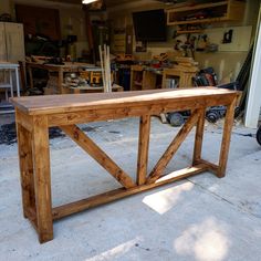 a wooden bench sitting inside of a garage