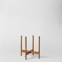 a small wooden table with two legs on one side and another leg in the other