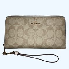 Nwt Coach - Signature Canvas Long Zip Around Wallet In Im / Light Khaki / Chalk Color W/ Wristlet Strap -This Exact Color Combination Not Available On Coach Website -The Stock Photos / Last Two Pictures Are From A Coach Website. Per Coach Website: Length: 7.5" Height: 4.0" Width: 1.0" -Detachable Wrist Strap -Inside Zip Coin Pocket -12 Credit Card Slots (6 On Each Side) -Full-Length Bill Compartments Elegant Handheld Travel Wallet, Elegant Handheld Travel Wallets, Chic Travel Wallets With Wrist Strap, Elegant Handheld Wallet With Card Slots, Elegant Beige Wristlet For Travel, Elegant Handheld Wallets For Daily Use, Handheld Wallets As Gifts, Elegant Coach Wristlet For Travel, Elegant Handheld Wallets With Card Slots