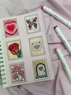 a notebook with stamps and markers on it