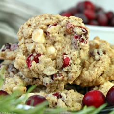 cranberry oatmeal cookies stacked on top of each other with fresh cranberries in the background