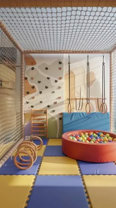 an indoor play area with toys and climbing ropes on the wall, in a children's room