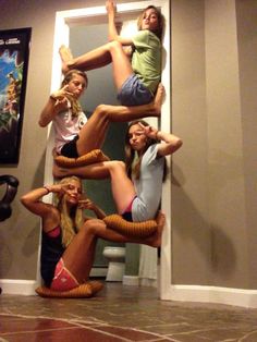 four girls are posing in the air with their hands on each other's hipss