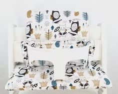 a white chair with an owl print on it