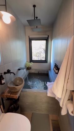 a bathroom with a tub, sink and window