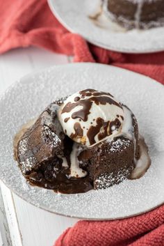 two white plates topped with brownies and ice cream