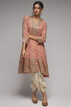 Editor's Note This pretty ensemble in this nusrat floral jaal, combines gota and dori buttis with an intricate border embroidery. The flared short kurta with a dhoti embroidered in sequins and gold thread, adds a feminine grace. Fabric: Kurta: georgette, dhoti: cotton Color: Pink Component: Dhoti and kurta Occasion: Festive Note: Product colour may slightly vary due to photographic lighting sources Care: Dry Clean Only About the Designer Gopi Vaid, co-founder of the eponymous label, is a designe Gopi Vaid, Co Ords Outfits, Simple Kurti Designs, Dhoti Pants, Indian Fashion Designers, Clothing Websites, Embroidered Tunic, Gold Thread, Desi Fashion