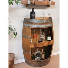 a wooden barrel with wine glasses and bottles on it