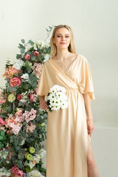 "Silk Toga Dress in Greek style. The dress was created from soft fabric with silk texure. Draped front style inspired by ancient Greek and Roman toga fashion. Due to the fabric, it is extra light and comfy to wear in the hot season. The design is very light and airy. A bit oversized cut is a great fit for the modest and ladylike image. The ruffle back with a V cut creates a delicate accent. Comfy to wear, move and dance. It is also festive and modest and suits for visiting the church ceremonies V-neck Maxi Dress For Wedding Night In Spring, Elegant Fairy Dress For Bridesmaids In Spring, Elegant Spring Fairy Dress For Bridesmaids, Evening Flowy Faux Wrap Dress, Flowy Faux Wrap Evening Dress, Elegant Summer Bridesmaid Fairy Dress, Silk Wrap Dress With Flowy Fit, Flowy Wrap Dress For Evening, Spring Wrap Satin Dress