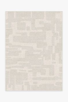 a beige and white rug with squares on the bottom, in an abstract pattern that looks like it has been made out of fabric