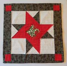 a red and white patchwork quilted on top of a table