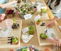 people sitting at a table with food and place cards