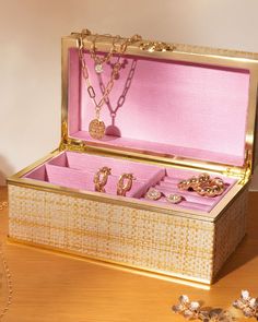 an open box with jewelry inside sitting on a table