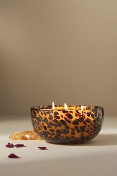 a leopard print bowl with candles in it