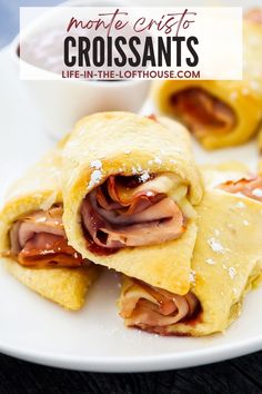 ham and cheese pastries on a plate with cranberry sauce