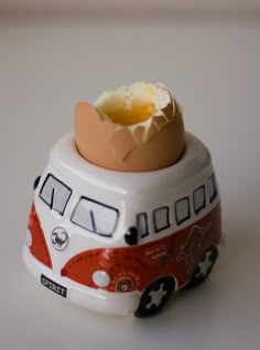 an egg is sitting on top of a bus shaped container that has eggs in it