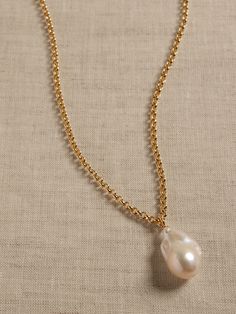 A highly lustrous single baroque pearl hangs from an adjustable-length gold-plated chain.  The pendant necklace makes a perfect pairing with our Pearl Strand Necklace.  Gold-plated brass and pearls.  Made in China.  Chain: 18-20" Pearl length approximately 0. 875" Large Pearl Necklace, Baroque Pearl Pendant, Preppy Jewelry, Pearl Strands Necklace, Diy Friendship Bracelets Patterns, Jewelry Logo, Pearl Strand, Baroque Pearl Necklace, Women's Jewelry And Accessories