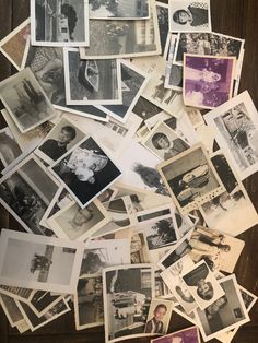 old black and white photographs are scattered on the floor