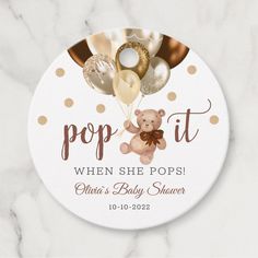 a baby shower sign that says pop it when she pops with balloons and a teddy bear