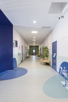 an empty hallway with blue and white walls