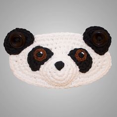 a crocheted panda bear head with buttons on it's eyes and nose