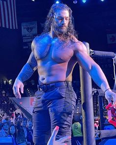 a man standing on top of a wrestling ring