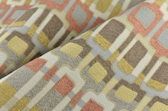 an upholstered, multicolored fabric with squares and rectangles on it