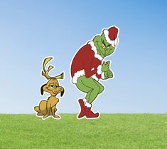 the grinch and his dog are standing in the grass