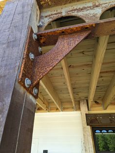 a close up of a metal object on the side of a wooden building with windows