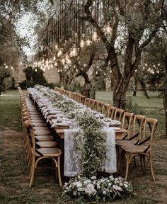 a long table set up for an outdoor dinner