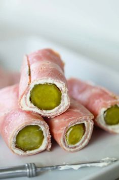 several pieces of raw meat with green olives