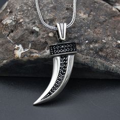 "Tusk Silver Necklace, Tusk Pendant, 925 Sterling Silver Necklace, Handmade Turkish Necklace, Tusk Charm With Chain, Birthday Gift ✦ Details ✦ * Material: 925 Sterling Silver * Weight of pendant : 5,20 gram *  Chain Weight :     20 Inches = 5.00 Gr     22 Inches = 5.60 Gr     24 Inches = 6.05 Gr     26 Inches = 6.10 Gr     28 Inches = 6,40 Gr * Decorated with Red Garnet and Micro Onyx stones. * Stamp: 925 ✦ Shipping ✦ * Processing time: 1-3 business days. * This item ships from my Turkish workshop in Istanbul. * Add your phone number in address box for a smoother delivery. That makes courier personnel's job easier.  ✦ Packaging ✦ * Comes with a luxury gift box and a jewellery cleaning cloth and courtesy gift. ✦ Returns, Exchanges ✦ * Return option available for 30 days after the delivery. Tusk Pendant, Luxury Gift Box, Onyx Stone, Red Garnet, Cleaning Jewelry, Sterling Silver Necklaces, Silver Pendant, Onyx, Jewelry Art