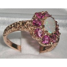 *This flower ring is made from 585 14K Rose Gold with Genuine Natural Semi-precious Opal & Pink Tourmalines.Like all my jewelry pieces, this ring is made in my own workshop. PLEASE MAKE SURE YOU STATE THE FINGER SIZE YOU REQUIRE WITH YOUR PAYMENT AND ALSO INCLUDE YOUR TELEPHONE NUMBER FOR DELIVERY COURIER.A beautiful Opal & Pink Tourmaline Ring set with a center 7x5mm (0.28"x0.20") Opal & eight 3.25mm (0.13" inches) vibrant Pink Tourmalines in a stylish Victorian Style cluster settin Rose Gold Multi-stone Pink Sapphire Jewelry, Rose Gold Multi-stone Jewelry With Pink Sapphire, Pink Opal Gemstone Ring For Anniversary, Elegant Pink Opal Ring For Anniversary, Rose Gold Tourmaline Wedding Ring, Pink Tourmaline Wedding Jewelry, Elegant Pink Oval Flower Ring, Pink Opal Ring Fine Jewelry, Pink Opal Ring For Anniversary, Fine Jewelry