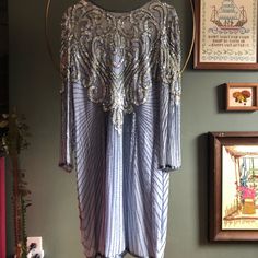 a dress hanging on a wall next to pictures