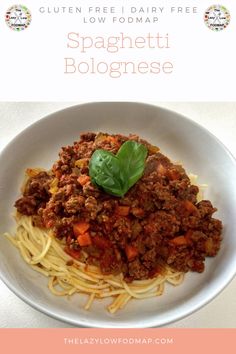 spaghetti bolognzoe with meat and vegetables in a white bowl