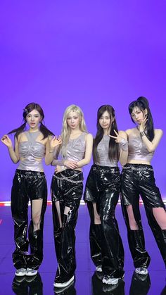 the girls are wearing shiny black pants and silver tops