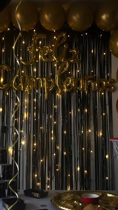 a party with gold balloons and streamers