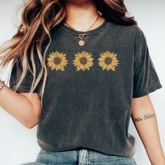 This vintage 90s sunflower T-shirt is a throwback to a better time in fashion! Revisit the fun of the Sunflower of the 1990s style fashion and wear this Comfort Colors tee! Gift it to your favorite 90s Baby, Retro lover or best friend! Comfort Colors introduces its garment-dyed t-shirt; a fully customizable tee made 100% with ring-spun cotton. The soft-washed, garment-dyed fabric brings extra coziness to your wardrobe while the relaxed fit makes it an excellent daily choice. The double-needle stitching throughout the tee makes it highly durable while the lack of side-seams helps the shirt retain its tubular shape. .: 100% ring-spun cotton .: Medium fabric (6.1 oz/yd² (206.8 g/m .: Relaxed fit .: Sewn-in twill label Sunflower Tshirt, Air Clothes, Vintage Sunflower, 90s Throwback, Paris Inspired, Botanical Shirt, 1990s Fashion, Comfort Colors Tee, Retro Flowers