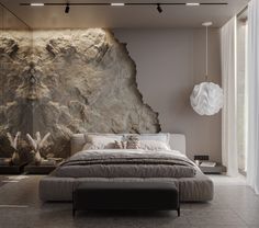 a bedroom with a large stone wall behind the bed