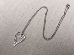 "This is such a unique and whimsical heart pendant necklace. It has incredible detail and another little heart showcased inside the main heart. This would make a very sweet and meaningful gifts for a loved one on any occasion. The heart measures 1\" long by 5/8\" wide and is made from allergy free plated silver. It hangs from a simple 18\" stainless steel necklace chain. I have matching earrings in my shop, if you would like the whole set. Here is the link https://etsy.me/30EwF2x Thanks for stop Nickel-free Heart Pendant Necklace For Valentine's Day, Nickel-free Heart Necklace For Valentine's Day, Nickel-free Open Heart Necklaces For Anniversary, Silver Heart Detail Necklace Gift, Nickel-free Open Heart Necklace For Anniversary, Silver Heart Detail Necklace For Gift, Valentine's Day Nickel-free Heart Pendant Necklace, Nickel-free Heart Pendant Charm Necklace For Valentine's Day, Nickel-free Heart Pendant Necklace For Anniversary