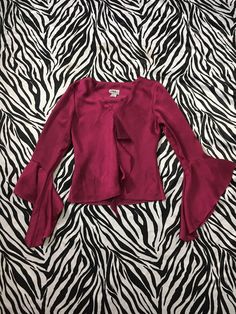 "90s Vintage Bell Sleeve Ruffle Blouse in Shiny Deep Magenta Color I'm in love with this beautiful, romantic style magenta blouse! Ruffle accent down the front and flowy bell sleeves. Reminds me of a medieval style sleeve. Gorgeous deep purple, magenta jewel tone color. The fabric is a polyester but has a sheen to it like a polyester taffeta. This color photographs as a red wine tone but in real life there's a little more purple in it. Made in USA Brand: J.B.S. Ltd Tag Size: Small Measurements ( Feminine Ruffled Tops, Party Tops With Ruffles And Bell Sleeves, 90s V-neck Tops For Fall, Fitted Flirty Fall Blouse, Flirty Fitted Blouse For Fall, Fitted Flirty Blouse For Fall, Stretch Bell Sleeve Tops For Party, Flirty Fitted V-neck Blouse, Spring Bell Sleeve Blouse For Night Out