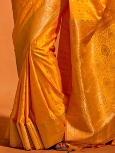 Wear this designer saree with amazing trending zari weaving work to create fashion statements. This yellow saree can be adorned at festivals and events. Made with yellow color silk material, it exudes elegance and charm. The zari weaving work adds a touch of traditional beauty to the saree, making it perfect for wedding ceremonies, cocktail parties, festivals, and marriages.
The saree comes with attached tassels, enhancing its overall appeal. The matching yellow color silk material blouse with z Yellow Saree With Cutdana Embroidery, Yellow Saree With Cutdana, Yellow Art Silk Blouse Piece For Navratri, Yellow Saree With Unstitched Blouse For Diwali, Yellow Saree With Zari Work For Festivals, Yellow Dola Silk Blouse Piece For Puja, Yellow Unstitched Blouse Piece For Festivals, Yellow Saree With Cutdana For Navratri, Yellow Art Silk Saree