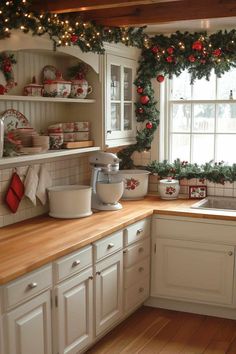 29 Ways To Decorate Kitchen Cabinets for a Festive Christmas Christmas Decor Over Cabinets, Christmas Decor Top Of Cabinets, Decorating Kitchen Window For Christmas, Christmas Garland Over Kitchen Cabinets, Cupboard Christmas Decorations, Top Of Cabinet Decor Kitchen Christmas, Under Cabinet Christmas Decor, Christmas Cabinets Ribbon, Over Cabinet Christmas Decor Kitchen