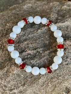 This bracelet is made with white glass beads, rhinestone spacers and red faceted beads. Note: Colors may vary depending on your monitor Shipping Info: All orders are shipped from Canada and they are sent through Canada Post.  If you would like expedited shipping it will cost more and reach out and I can give pricing. Within Canada: Sent regular mail with no tracking.  It can take 5-10 business days to arrive. United States: Sent with tracking  International: Sent International Air and on average White Stretch Bracelet With Faceted Beads For Gift, White Faceted Adjustable Crystal Bracelet, White Crystal Bracelet With Faceted Beads For Gift, White Crystal Bracelet With Spacer Beads For Jewelry Making, Adjustable Faceted White Crystal Bracelet, Adjustable Faceted White Beaded Bracelets, White Adjustable Faceted Crystal Bracelet, Adjustable White Faceted Beaded Bracelets, Adjustable White Faceted Crystal Bracelet