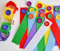 several different types of paper and buttons on a white surface with scissors, tape and other items