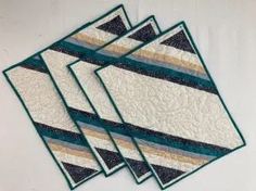 three quilted coasters sitting on top of each other